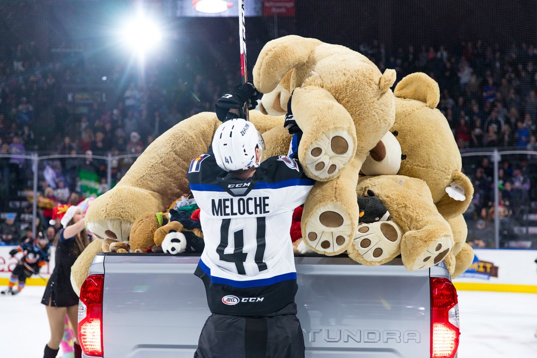 Providence Bruins fans throw teddy bears onto the ice for charity